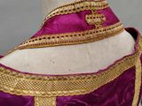 a close up of a purple and gold dress on a mannequin