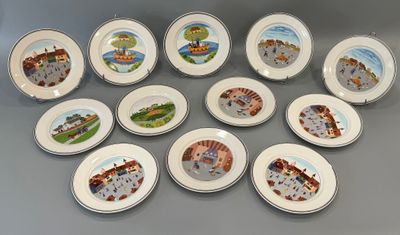 neuf assiettes ornées de motifs différents, posées sur une table