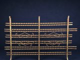 a pair of gold plated metal racks with geometric designs