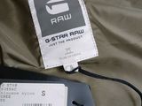 a label on the back of a jacket with a tag attached to it