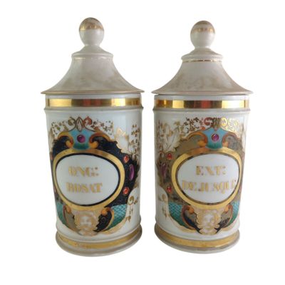 two white and gold canisters with a picture of a woman and a man