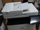 a printer sitting on top of a desk next to a cell phone
