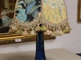 a lamp that is on a table in front of a mirror