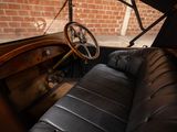 an old car with a steering wheel and a leather seat