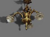 a gold colored chandelier with flowers on it