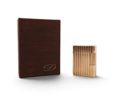 a wooden box with a lighter in it sitting next to it