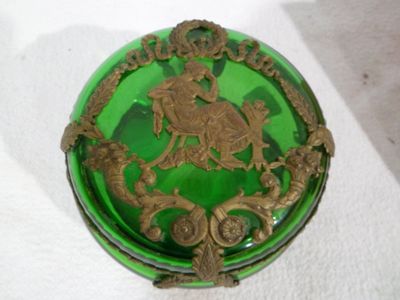 a green glass box with a gold decoration on it