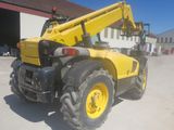 a yellow crane that is parked in front of a building