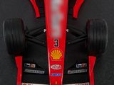 a close up of a red race car with a shell sticker on it