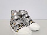 a close up of a pair of silver and leopard print shoes