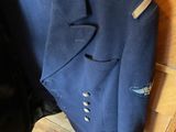 a blue jacket and a black jacket hanging on a wall