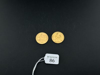 a close up of two gold coins on a black surface