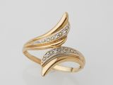 a gold ring with diamonds on a white background