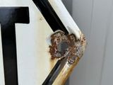 a close up of a rusted stop sign with a number one on it