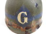 an old military helmet with the letter g painted on it