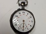 a black and white pocket watch on a white surface