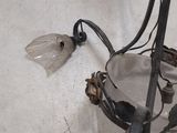 a silver plate with a flower on it on the floor
