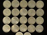 a lot of silver coins on a black surface