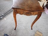 a small table with a wooden top in a room