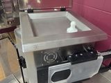 a small stove that is in the middle of a kitchen