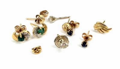 many different types of earrings on a white surface