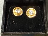 three gold and diamond studs in a black box