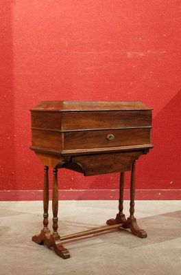 a small wooden table with a drawer on it