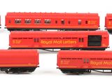 several red train cars are lined up on a white surface