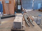 many pieces of wood on the floor in a warehouse