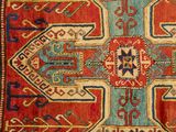 an old rug with a red and blue design on it