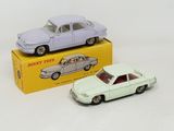 two toy cars sitting next to each other on a table