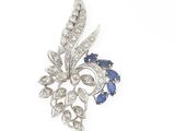 a close up of a diamond and sapphire broochle