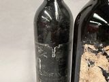 two bottles of wine sitting next to each other on a table