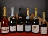 several bottles of wine are lined up on a red table