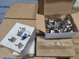 a box full of metal clips and a box full of paper clips