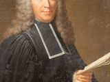 portrait of a man in a black robe holding a book