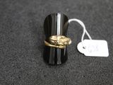 a ring with a snake on it sitting on a table