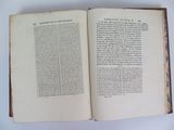 an open book on a table with a white background