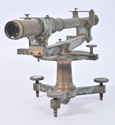 a very old looking telescope on a stand on a white surface