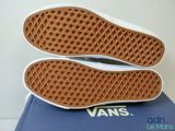 vans classic slip - on sneakers in white and blue on a blue box
