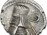 a silver coin with a man ' s face and a crown on it