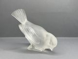 a glass bird that is sitting on a table