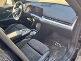 the interior of a car with the door open showing the dashboard