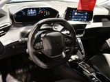 the interior of a car with a steering wheel and a display screen