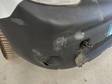 a car that has been dented and is parked in a garage