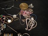 a lot of jewelry sitting on a table next to a keyboard