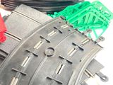 a pile of train tracks and a red and green toy train
