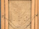 an old picture of a wooden frame with a rope hanging from it