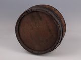 an old wooden barrel sitting on top of a white surface