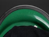 a close up of a black shirt on a green plate